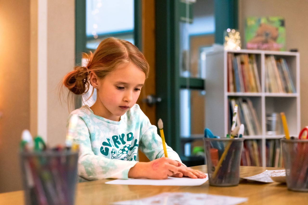 A young student at MVES works on an assignment in the classroom.